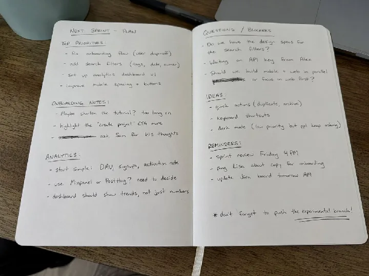 A casually opened notebook shows uneven handwriting and everyday paper texture.