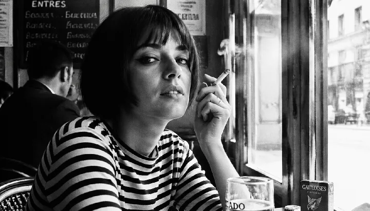 A candid cafe portrait evokes the grain and framing of French New Wave cinema.